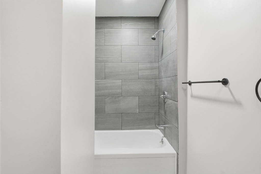 52 Osgood Street Springfield, MA 01107 - Photo 14 of 42 a bathroom with a bath tub and shower