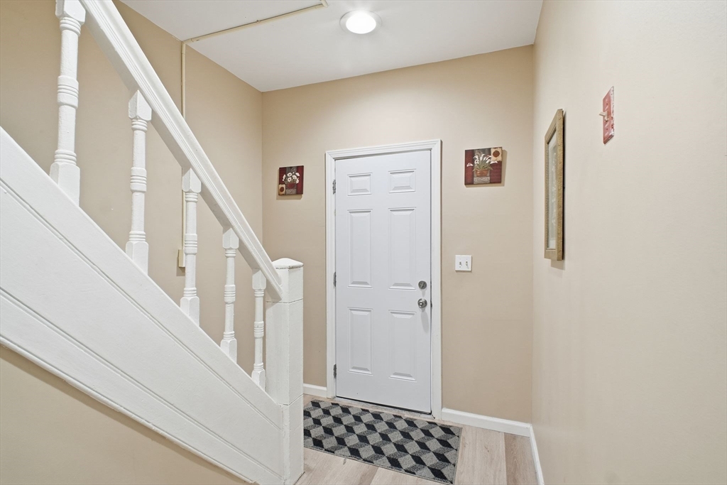 52 Osgood Street Springfield, MA 01107 - Photo 15 of 42 a view of a hallway with wooden floor and staircase