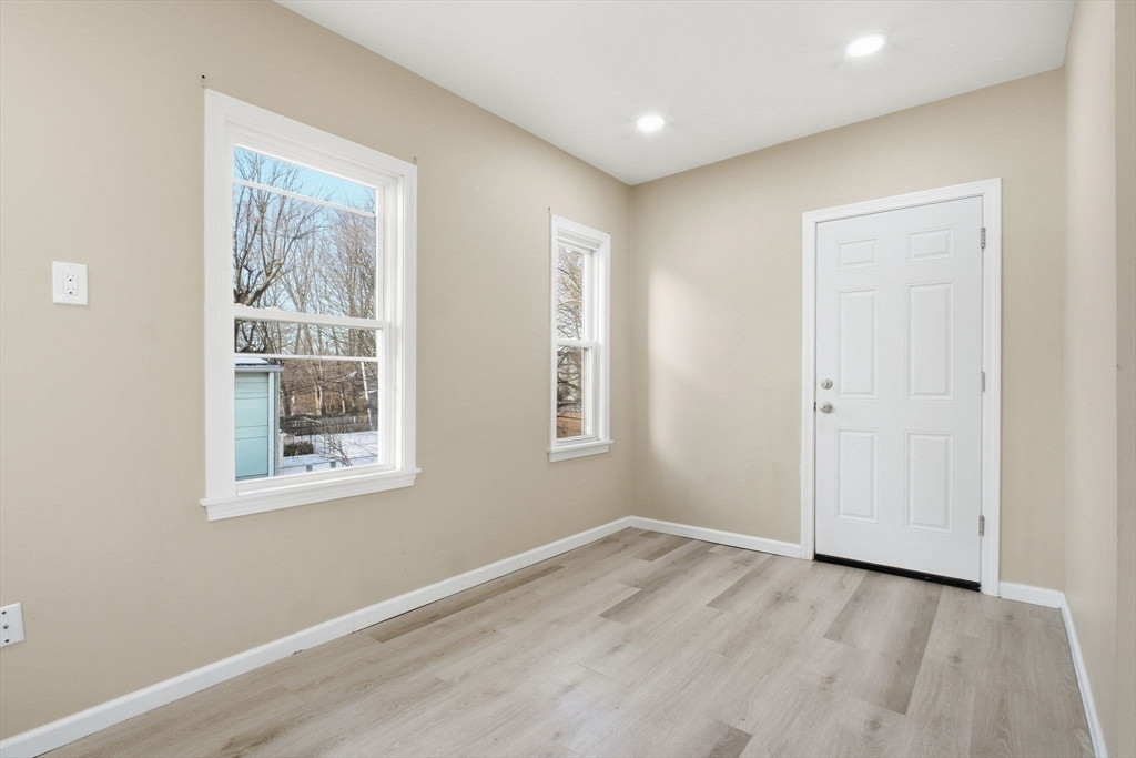 52 Osgood Street Springfield, MA 01107 - Photo 21 of 42 an empty room with wooden floor and windows
