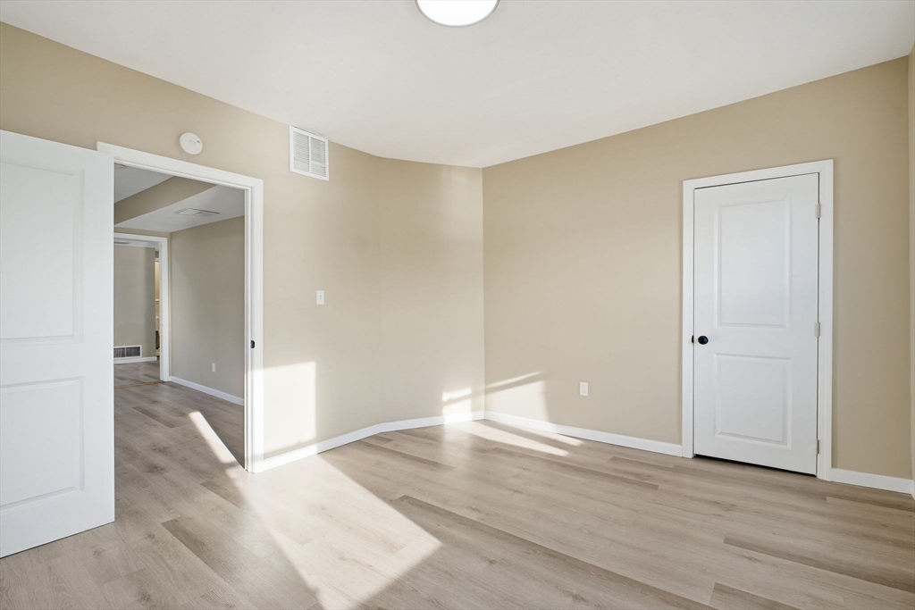 52 Osgood Street Springfield, MA 01107 - Photo 24 of 42 wooden floor in an empty room with a window