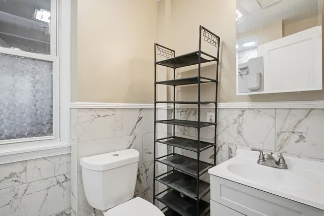 a white toilet sitting next to a bathroom sink