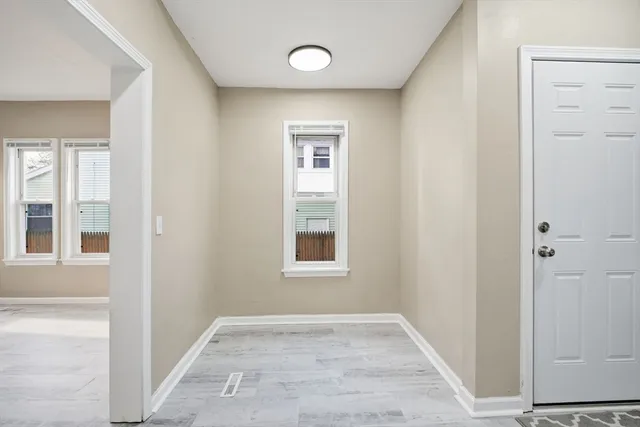 an empty room with windows and closet