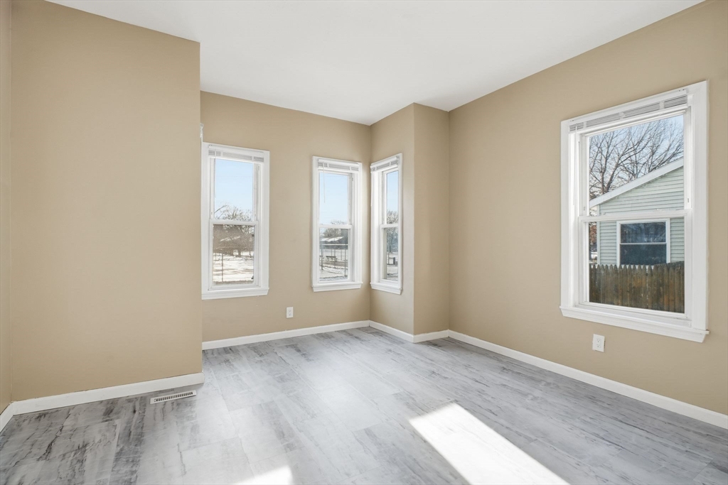 52 Osgood Street Springfield, MA 01107 - Photo 9 of 42 a view of an empty room with wooden floor and a window