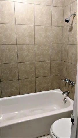 a bathroom with a sink a toilet and bathtub