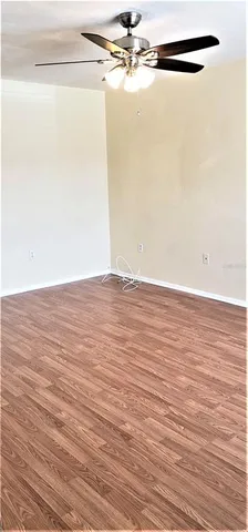 a view of a room with wooden floor