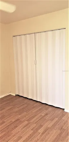 a view of a walk in closet with wooden floor