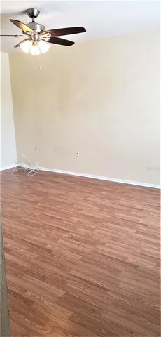 a view of a room with wooden floor