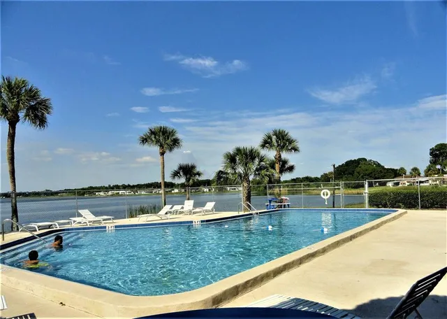 a view of a swimming pool with a lake view