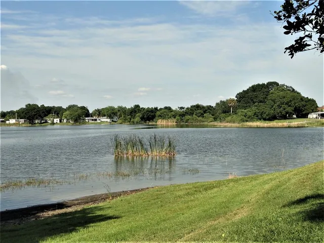 a view of a lake with houses in the back