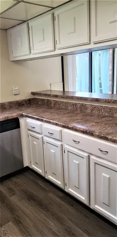 a view of a kitchen with granite countertop white cabinets and a granite counter tops