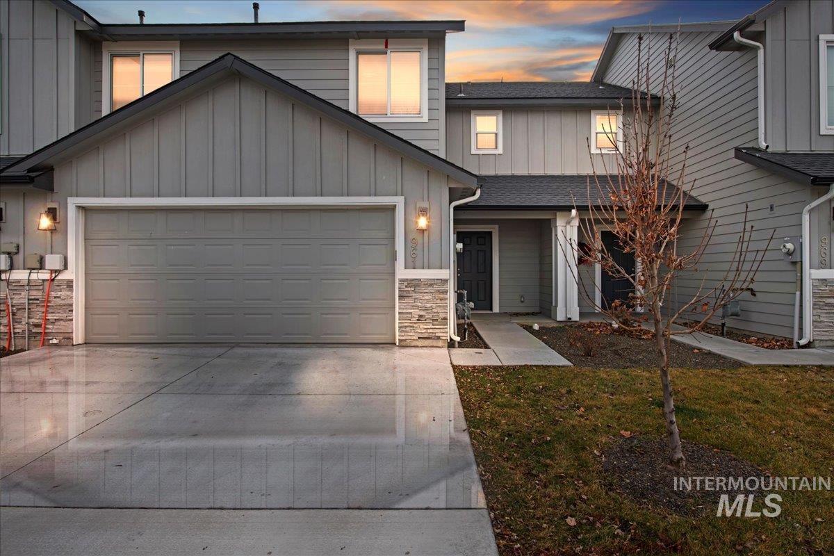 961 West Apple Pine Street Meridian, ID 83646 - Photo 1 of 30 View of front of property with an attached garage, board and batten siding, driveway, stone siding, and a front yard