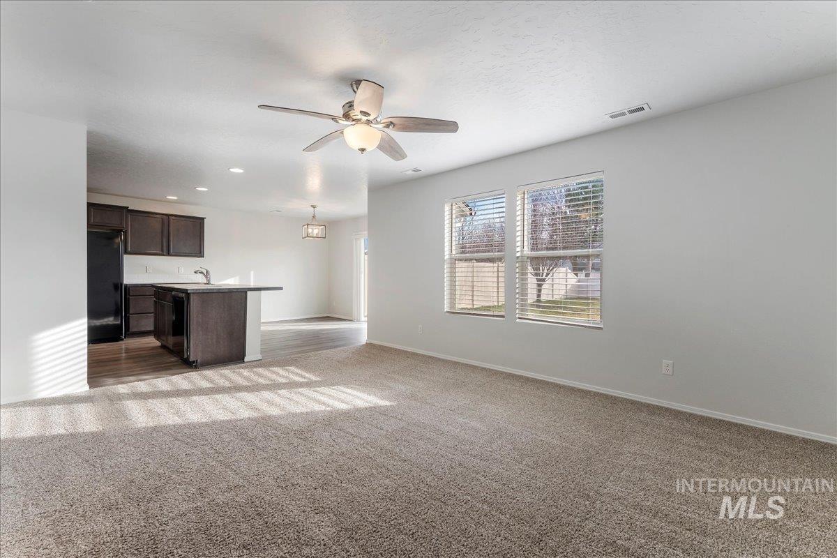 961 West Apple Pine Street Meridian, ID 83646 - Photo 10 of 30 Unfurnished living room with ceiling fan, dark colored carpet, and recessed lighting