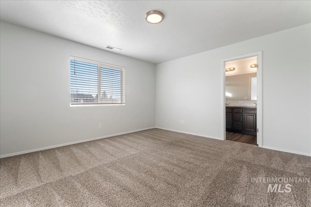 961 West Apple Pine Street Meridian, ID 83646 - Photo 14 of 30 Spare room with dark carpet and a textured ceiling
