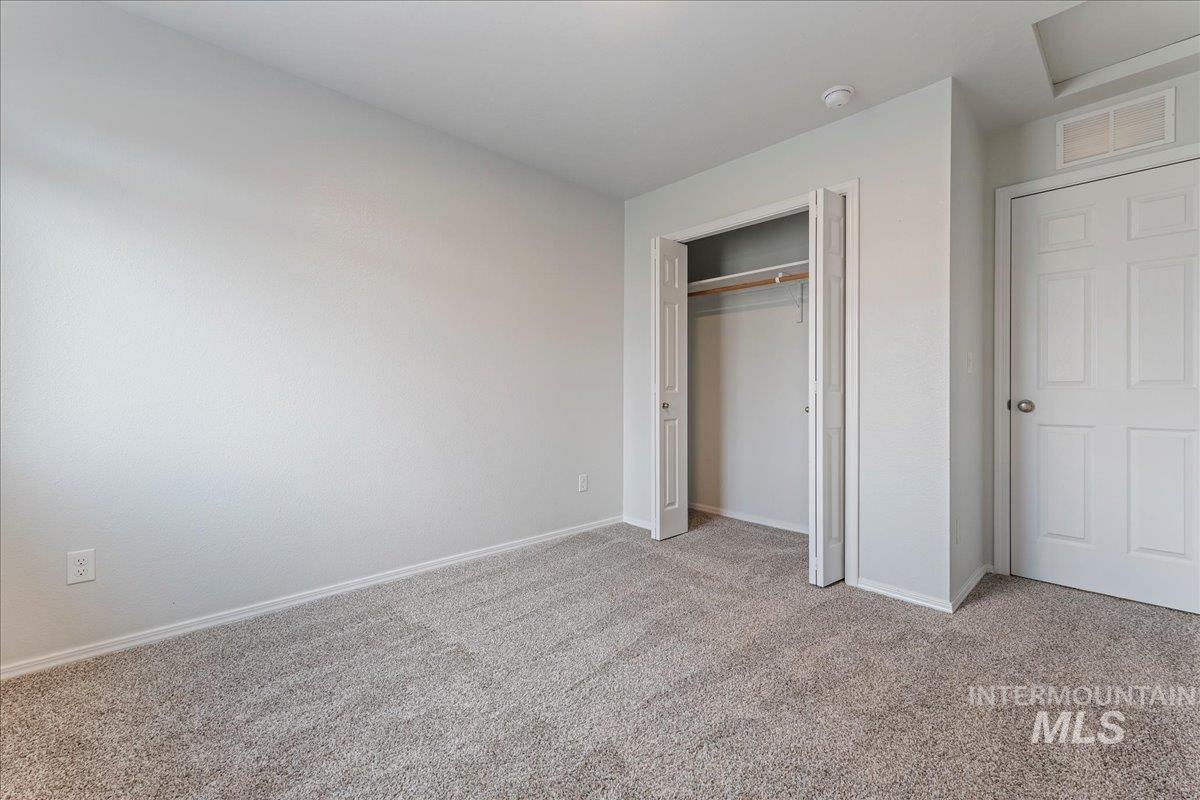 961 West Apple Pine Street Meridian, ID 83646 - Photo 18 of 30 Unfurnished bedroom with carpet and a closet