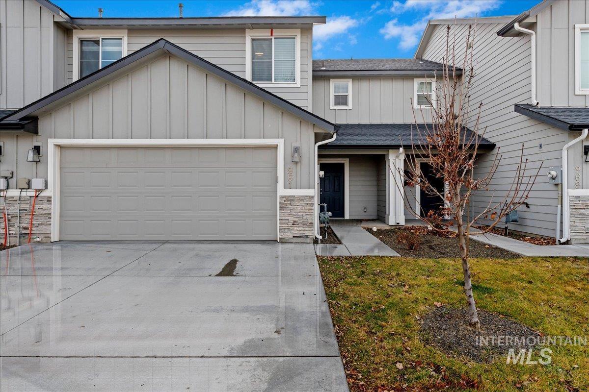 961 West Apple Pine Street Meridian, ID 83646 - Photo 2 of 30 View of front of house featuring board and batten siding, driveway, an attached garage, stone siding, and a front lawn