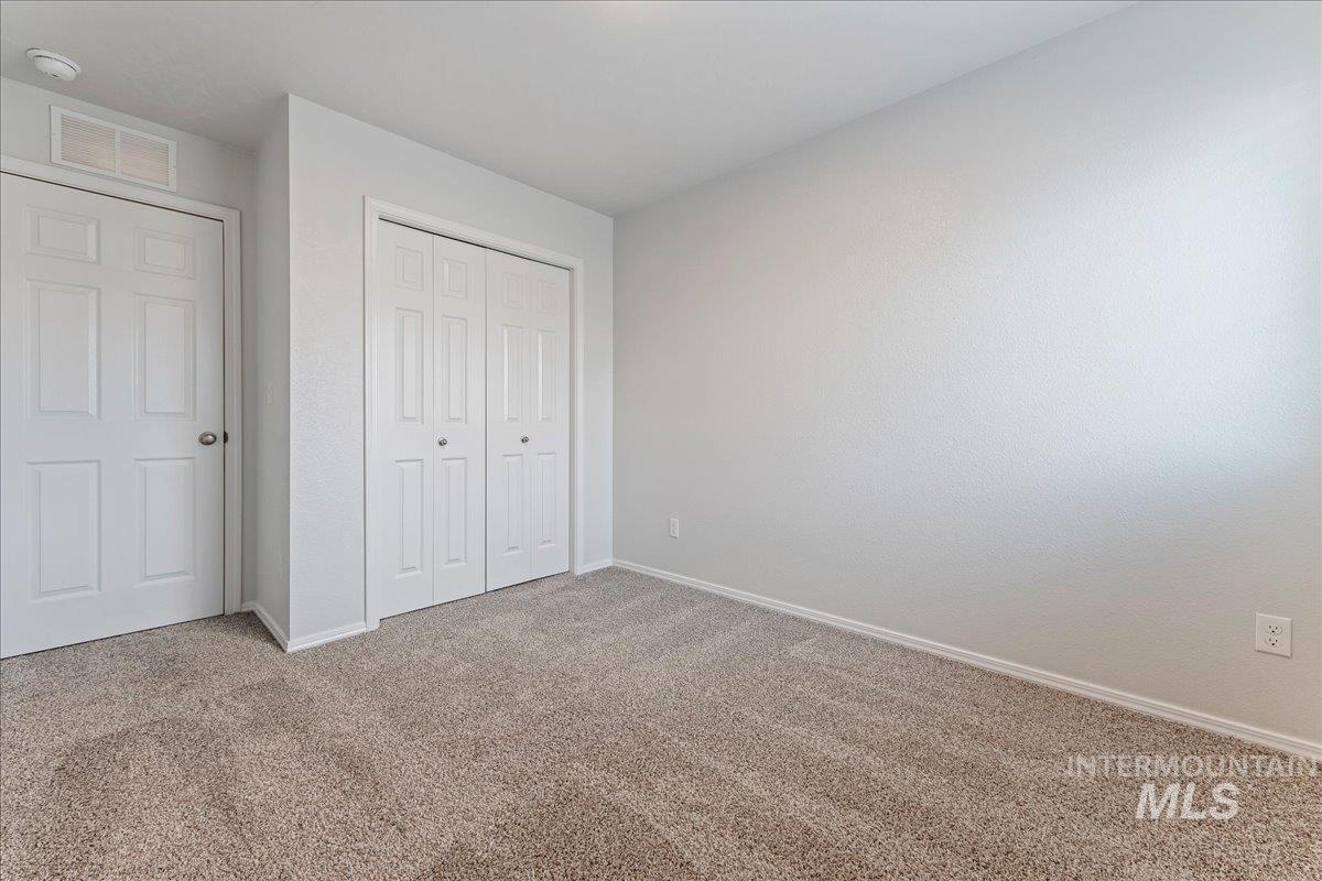 961 West Apple Pine Street Meridian, ID 83646 - Photo 22 of 30 Unfurnished bedroom with carpet floors and a closet