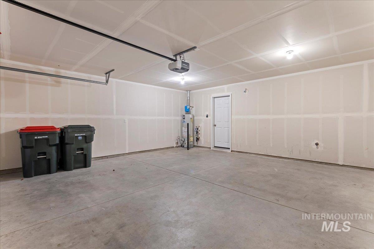 961 West Apple Pine Street Meridian, ID 83646 - Photo 29 of 30 Garage with gas water heater and a garage door opener