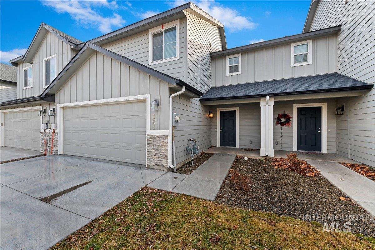 961 West Apple Pine Street Meridian, ID 83646 - Photo 3 of 30 View of front facade featuring board and batten siding, a garage, a porch, driveway, and roof with shingles