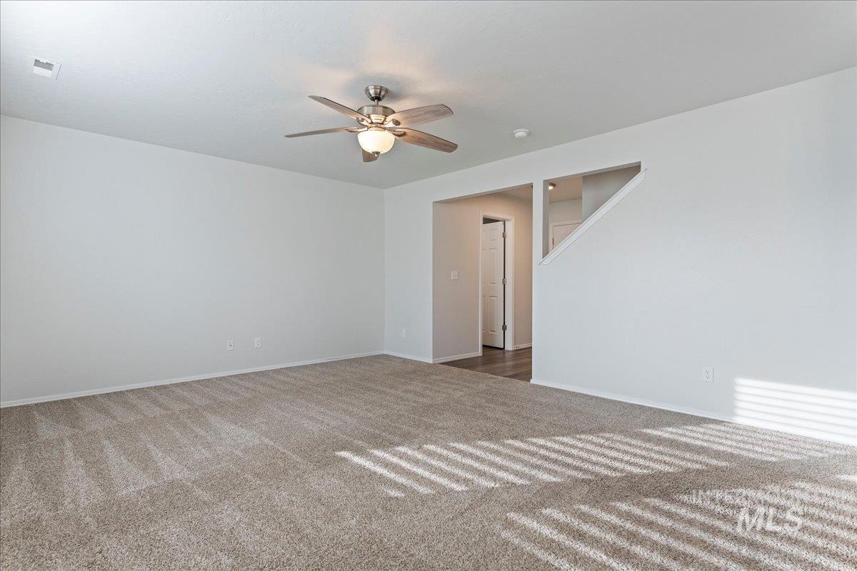 961 West Apple Pine Street Meridian, ID 83646 - Photo 9 of 30 Carpeted empty room with ceiling fan and baseboards