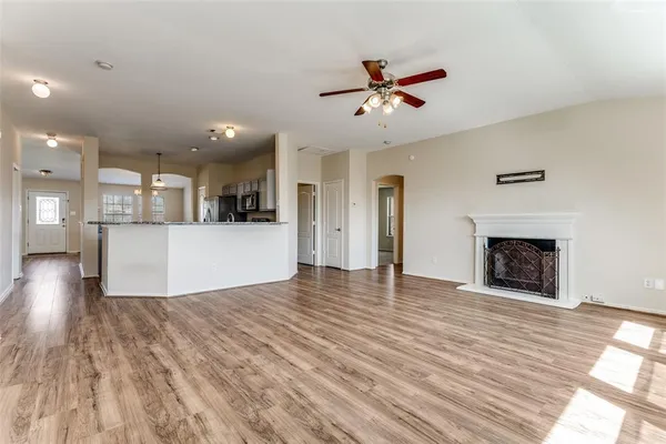 a view of a living room a kitchen with wooden floor and a kitchen
