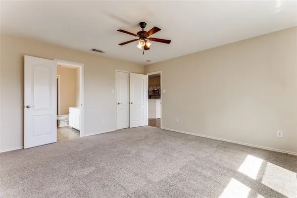 a view of a livingroom with a ceiling fan and window