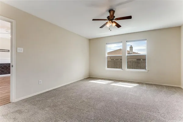 a view of room with a ceiling fan and window