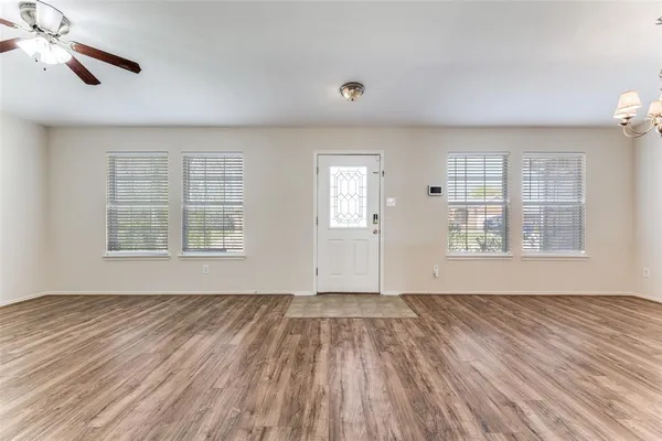 wooden floor in an empty room with a window