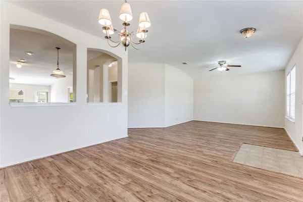 a view of a bedroom with wooden floor and chandelier