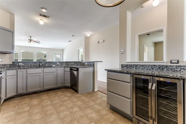 a kitchen with a stove sink and cabinets