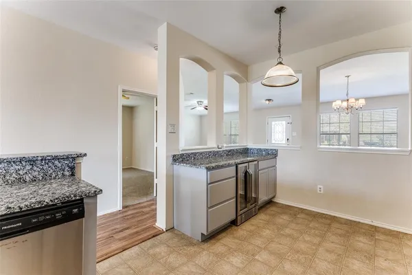 a kitchen with stainless steel appliances granite countertop a stove and a refrigerator