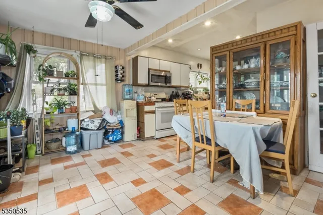 a dining room with furniture a chandelier and window