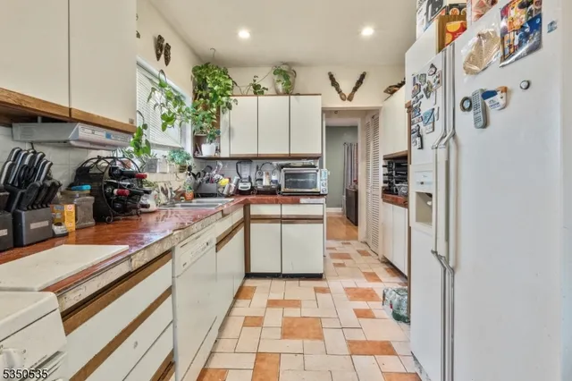 a kitchen with stainless steel appliances granite countertop a sink and cabinets