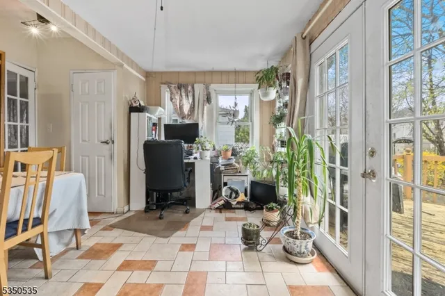 a view of a livingroom with furniture and a window