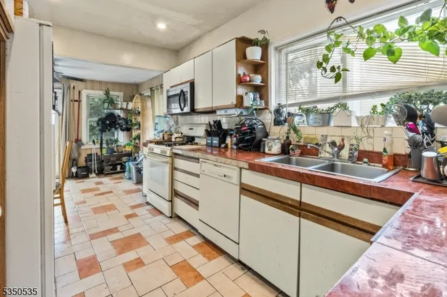 a kitchen with stainless steel appliances kitchen island granite countertop a sink and cabinets
