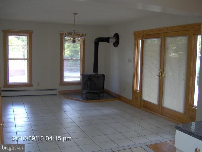 325 Silver Road Berkeley Springs, WV 25411 - Photo 14 of 21 a view of empty room with window and chandelier fan