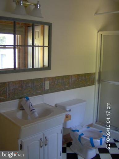 325 Silver Road Berkeley Springs, WV 25411 - Photo 19 of 21 a bathroom with a sink and a window