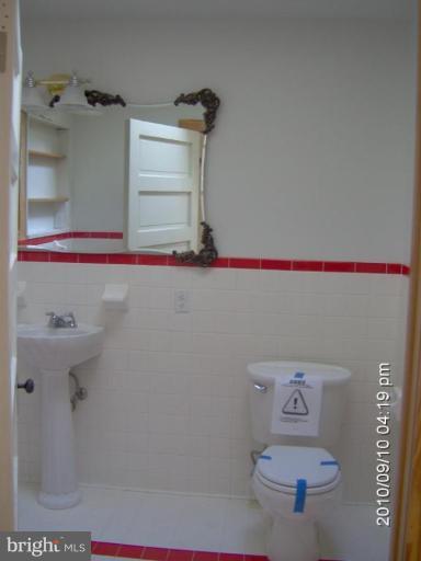 325 Silver Road Berkeley Springs, WV 25411 - Photo 20 of 21 a bathroom with a toilet and a sink