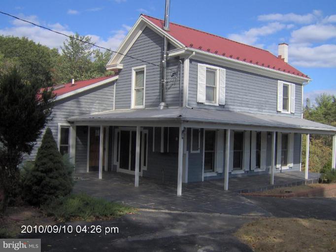325 Silver Road Berkeley Springs, WV 25411 - Photo 3 of 21 a front view of a house with a yard