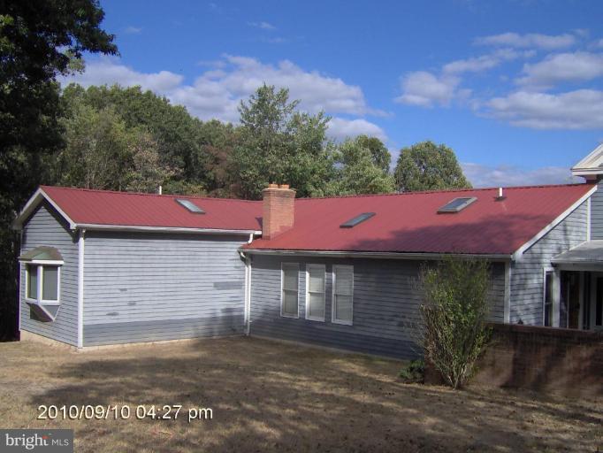 325 Silver Road Berkeley Springs, WV 25411 - Photo 6 of 21 a front view of a house with garden