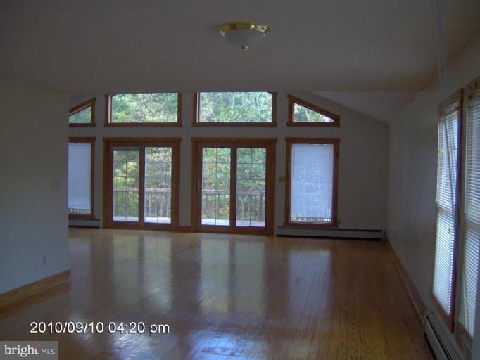 325 Silver Road Berkeley Springs, WV 25411 - Photo 10 of 21 a view of a room that has wooden floor