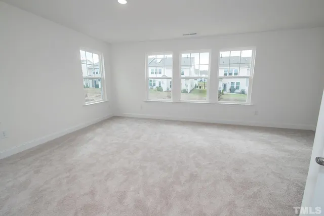 a view of an empty room and a window