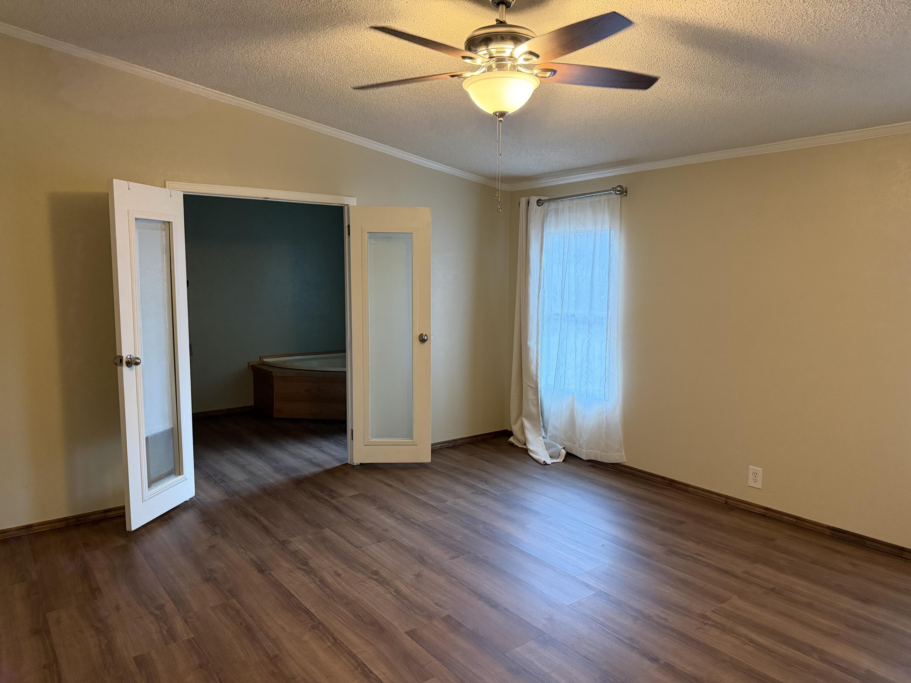 11120 Gentry Lane Slaton, TX 79364 - Photo 12 of 17 a view of a room with wooden floor