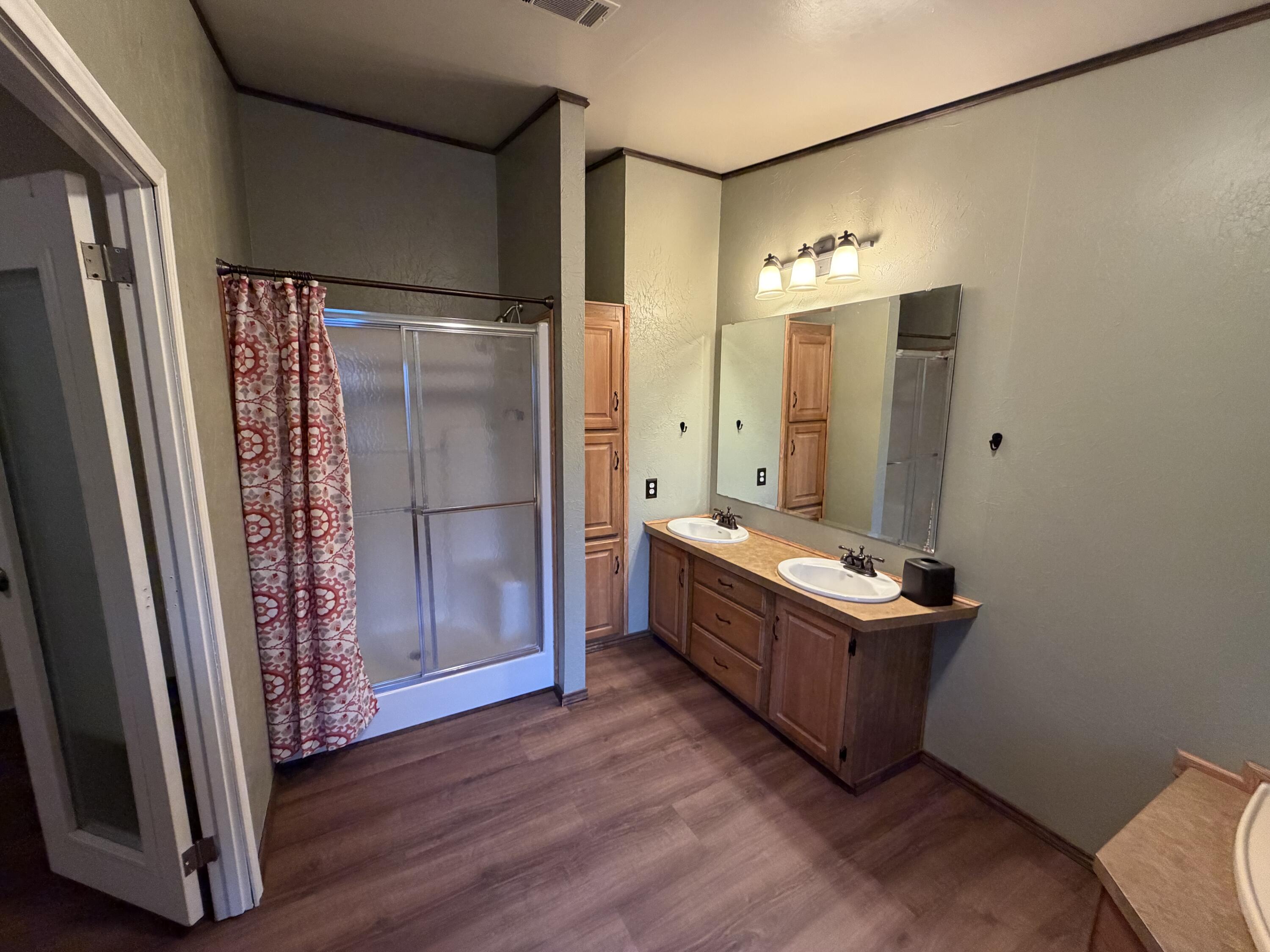 11120 Gentry Lane Slaton, TX 79364 - Photo 13 of 17 a room with window and a wooden floor