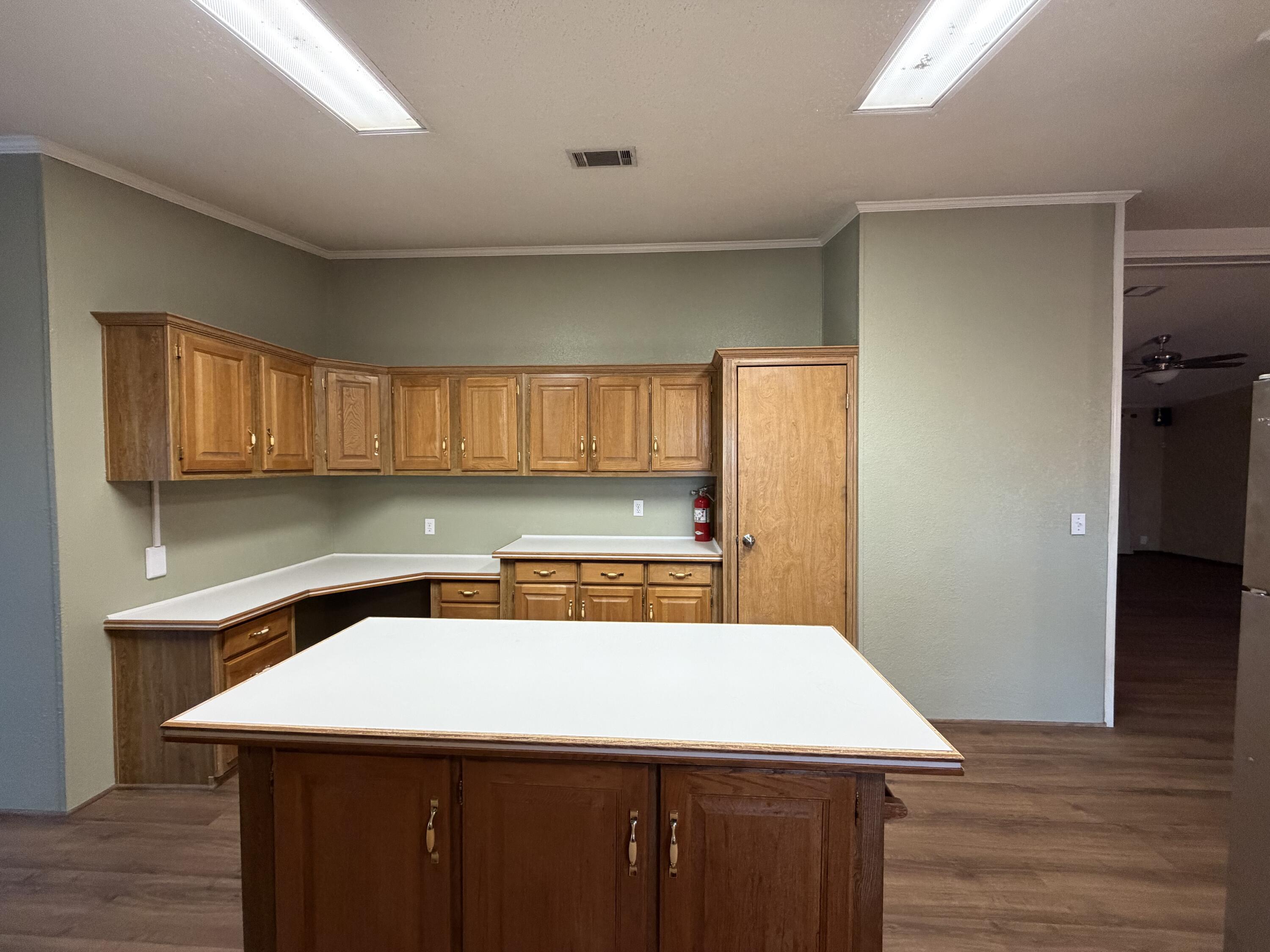 11120 Gentry Lane Slaton, TX 79364 - Photo 6 of 17 a room with a wooden floor and a sink