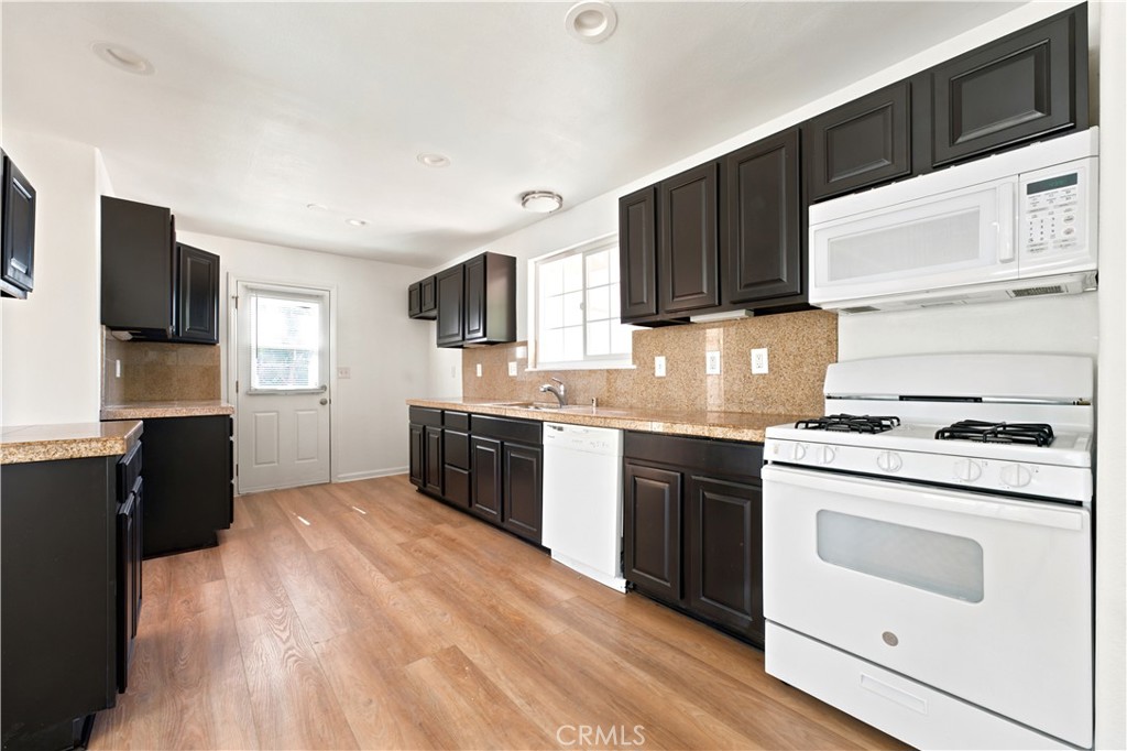 1720 Anderson Street Simi Valley, CA 93065 - Photo 3 of 30 a kitchen with stainless steel appliances a stove microwave and sink