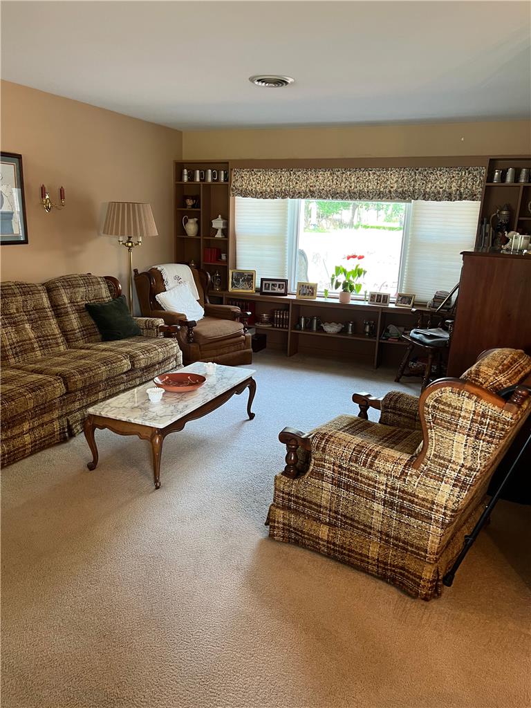6830 Gun Club Road Coopersburg, PA 18036 - Photo 18 of 30 A window-lit living room features built-in shelving, soft neutral carpeting, and a classic interior design.