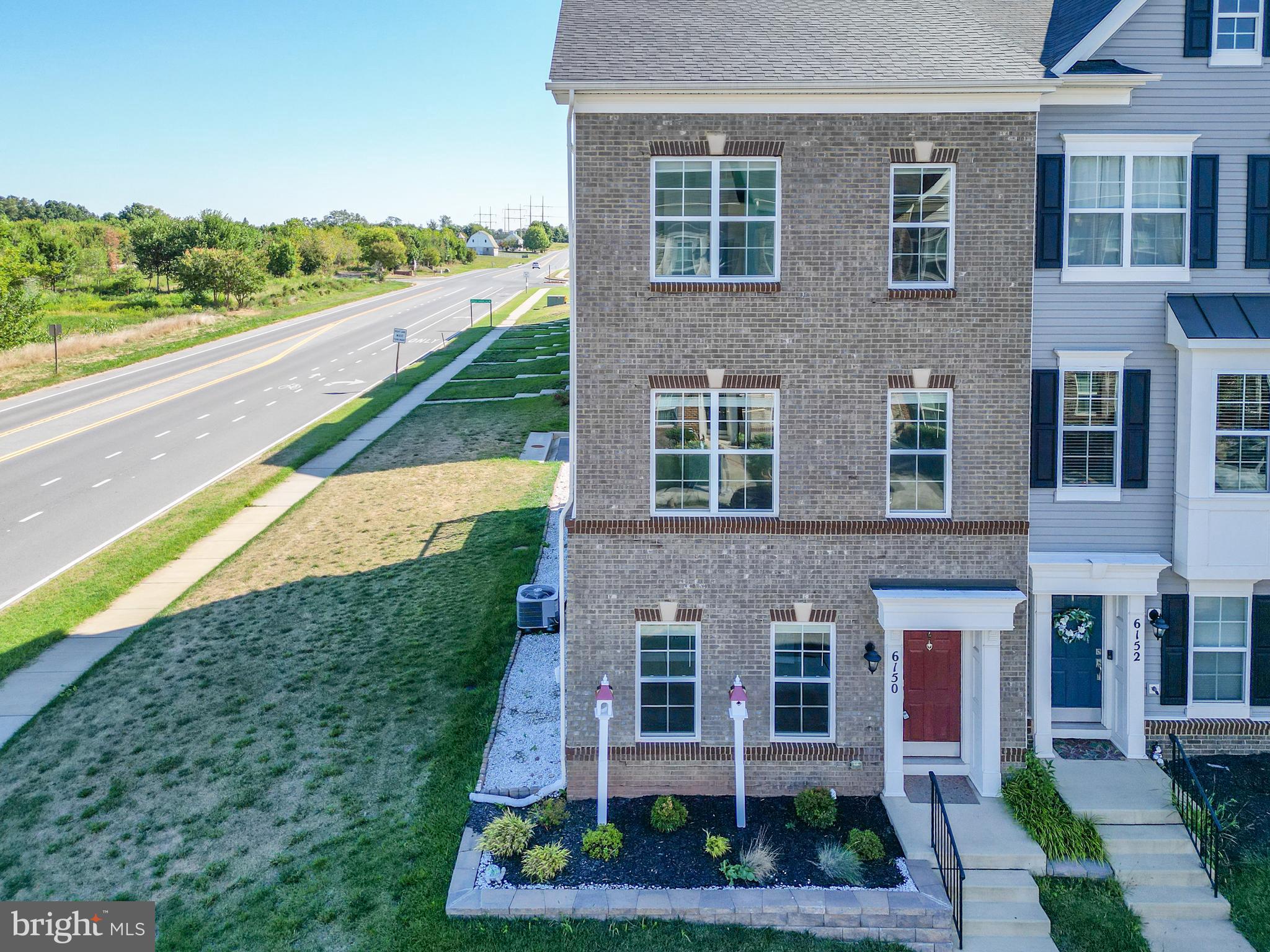 a view of a brick building next to a yard