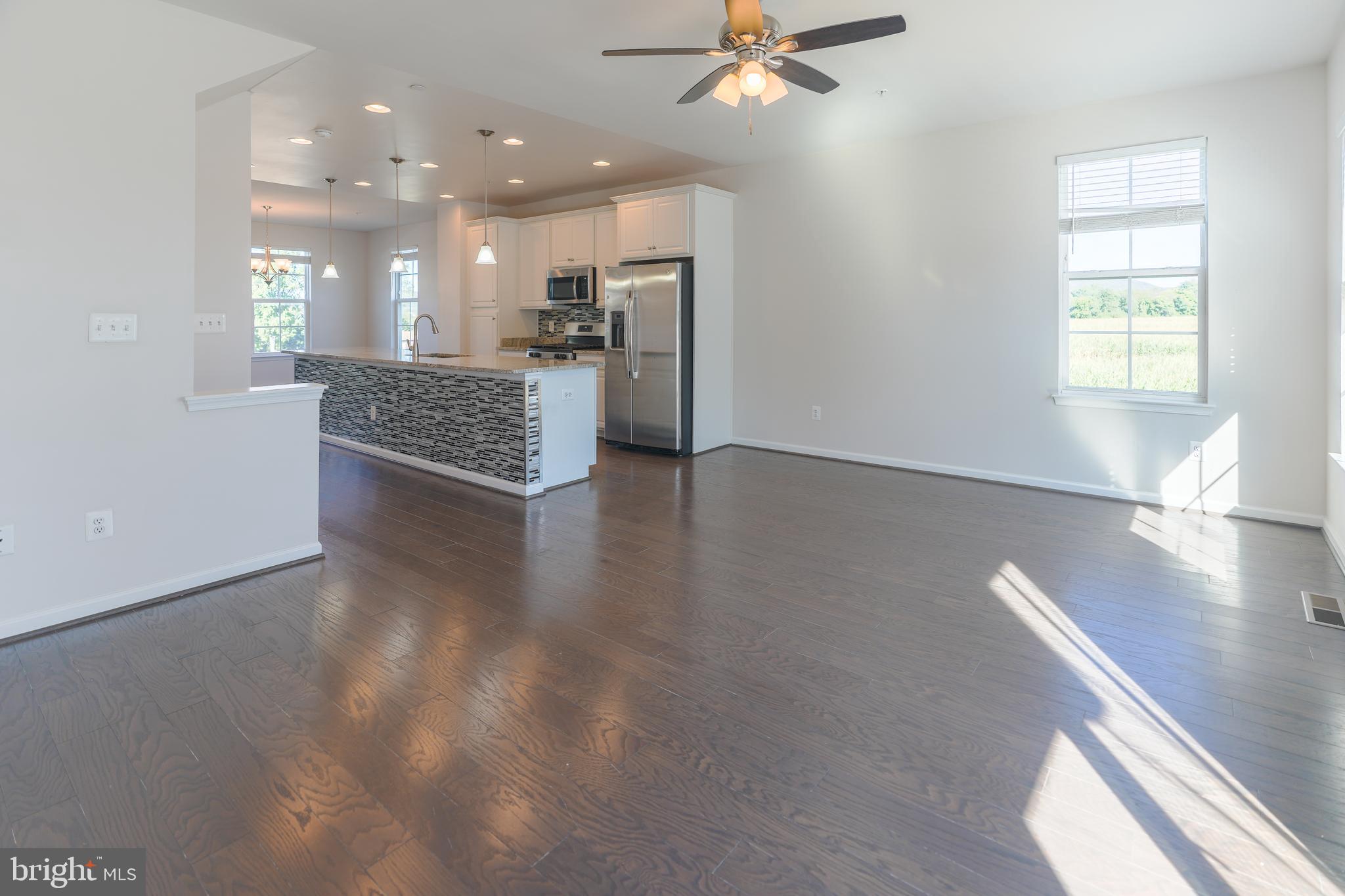 6150 Posey Street Frederick, MD 21703 - Photo 11 of 32 a view of a big room with wooden floor and windows