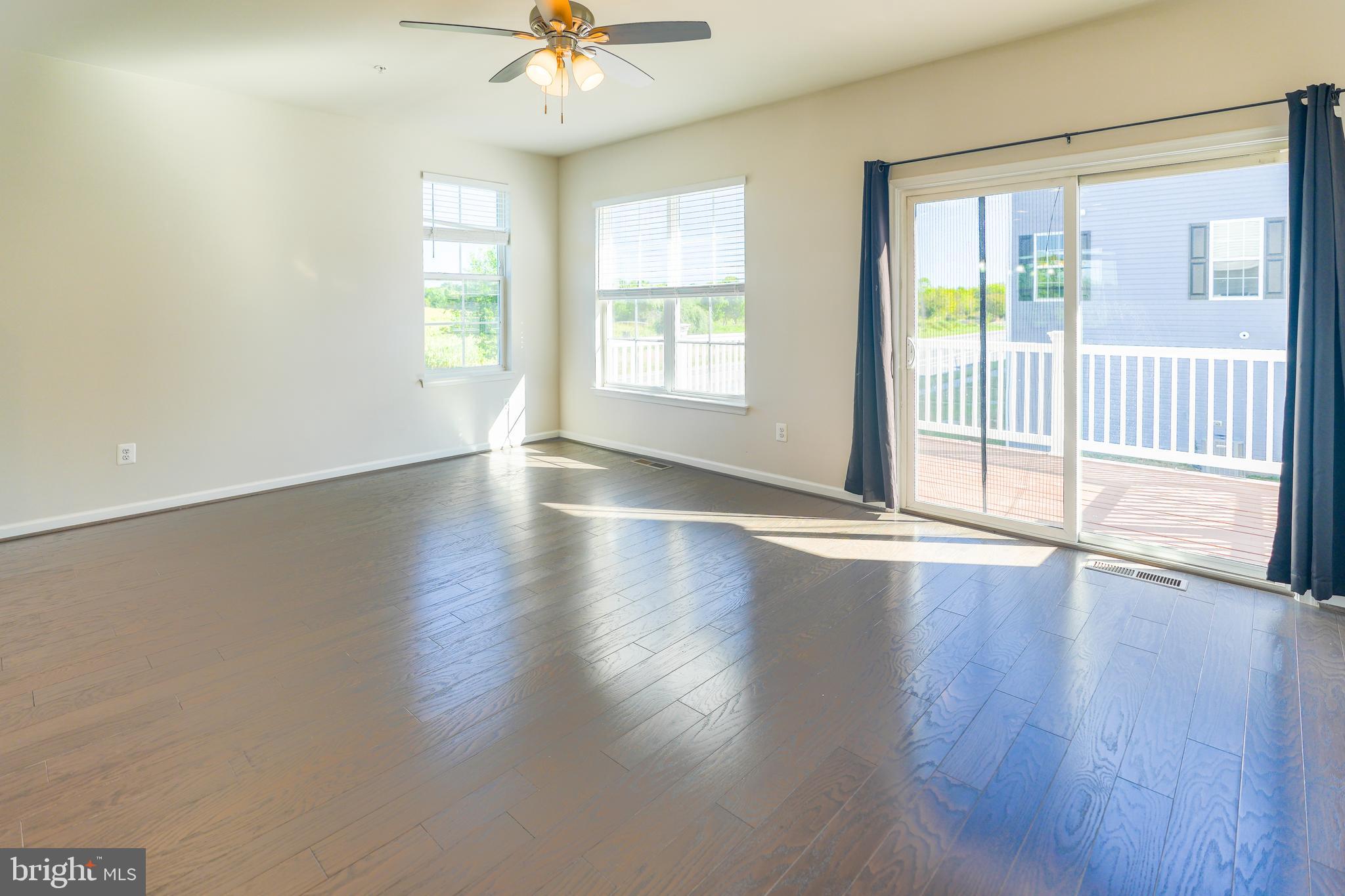 6150 Posey Street Frederick, MD 21703 - Photo 12 of 32 a view of an empty room with wooden floor and a window