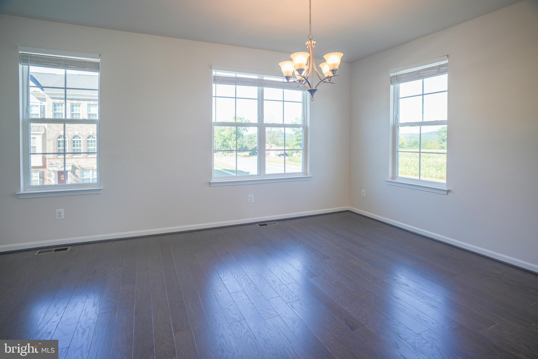 6150 Posey Street Frederick, MD 21703 - Photo 16 of 32 an empty room with wooden floor and windows
